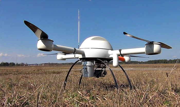 Figure 3: Radiation detector subsystem shown in a previous application, mounted in a cylindrical enclosure to the underside of a miniature UAV helicopter.